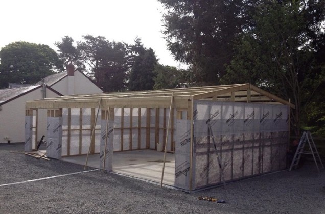 double timber frame garage with wood shed